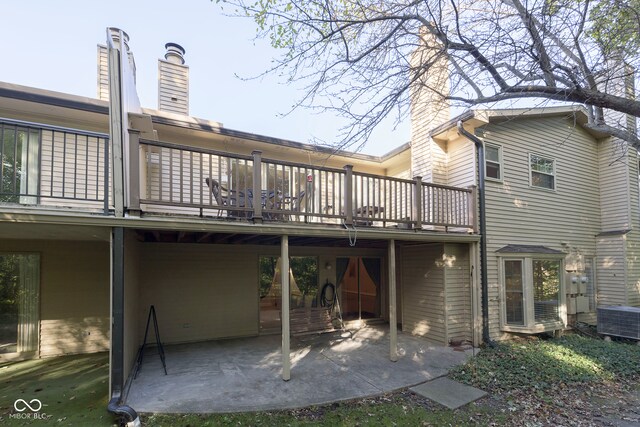 rear view of property featuring a patio and central AC unit