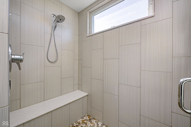 bathroom with tiled shower