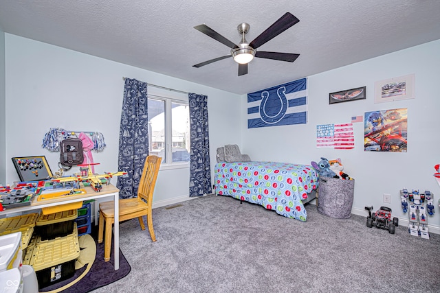 carpeted bedroom featuring ceiling fan and a textured ceiling