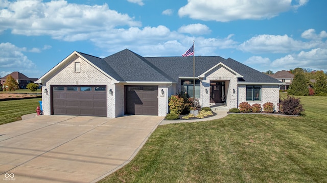 view of front of home featuring a garage and a front yard