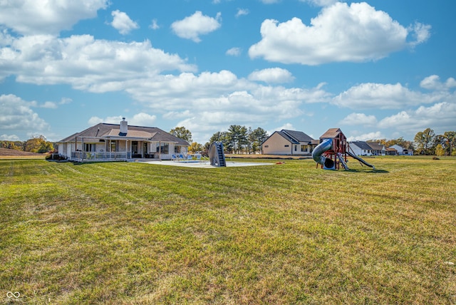 view of yard with a playground and a swimming pool