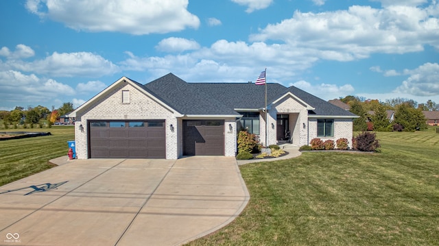 view of front of property featuring a garage and a front lawn