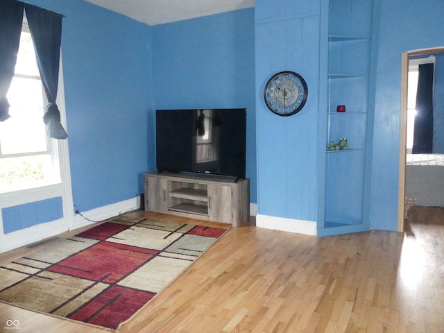 unfurnished living room featuring wood-type flooring