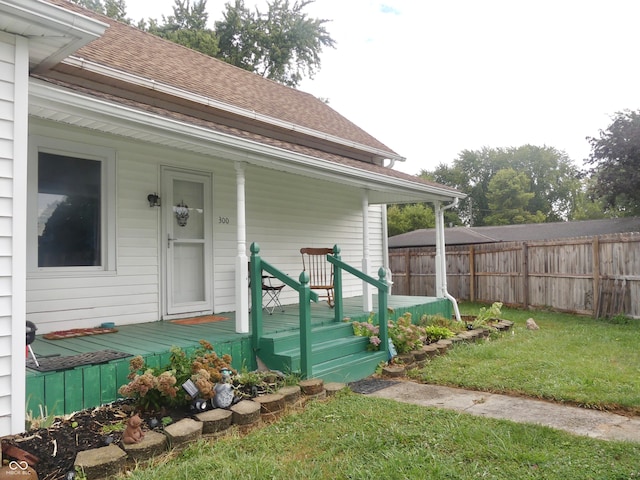 doorway to property with a lawn