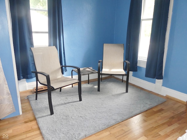 living area with hardwood / wood-style flooring