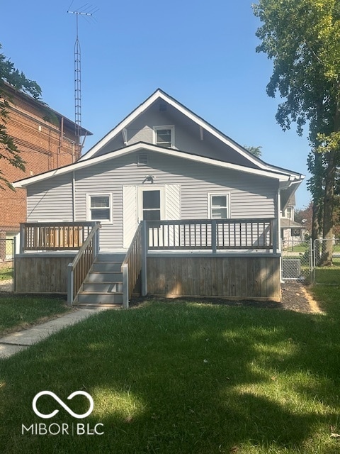 rear view of house with a wooden deck, cooling unit, and a yard