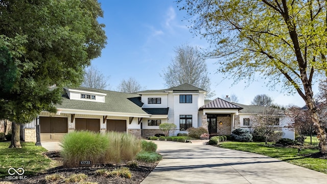 view of front of property with a front yard and a garage