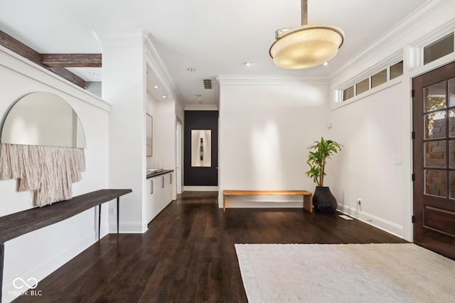 foyer with crown molding and dark hardwood / wood-style flooring