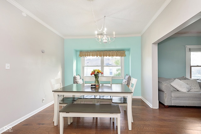 dining room featuring ornamental molding, dark wood-type flooring, and a chandelier