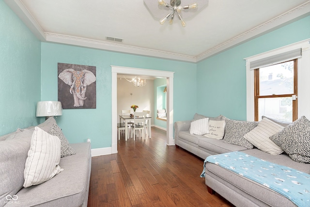 living room featuring ornamental molding, a chandelier, and dark hardwood / wood-style floors