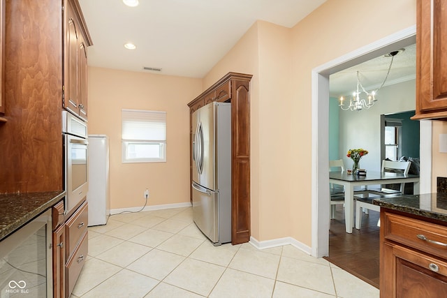 kitchen with a chandelier, crown molding, dark stone countertops, wine cooler, and appliances with stainless steel finishes