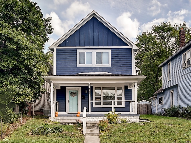 view of front of home with a porch and a front yard