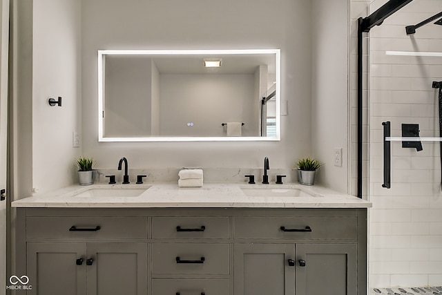 bathroom with vanity and a shower with door