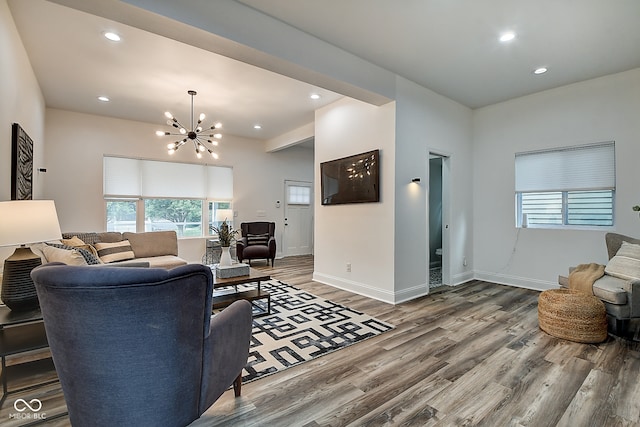 living room featuring wood-type flooring and a chandelier