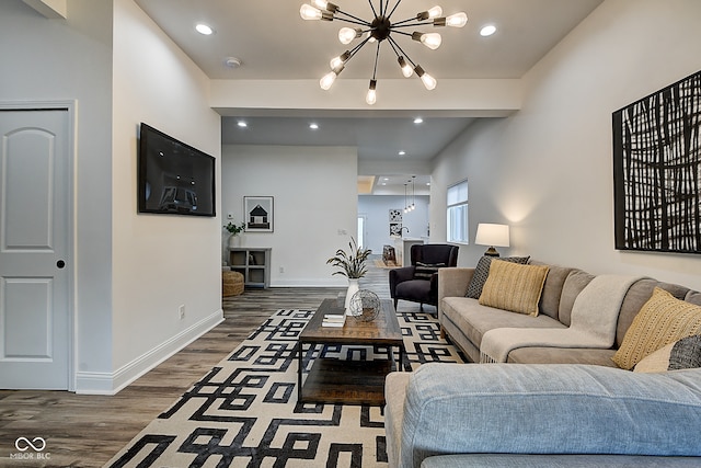 living room with a notable chandelier and dark wood-type flooring