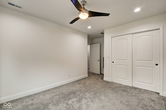 unfurnished bedroom with a closet, ceiling fan, and carpet floors