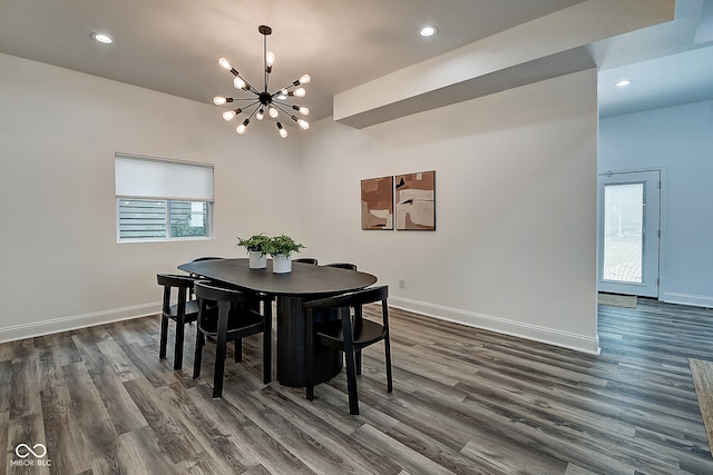 dining space featuring dark hardwood / wood-style floors and a notable chandelier