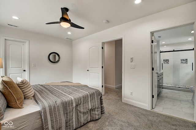 carpeted bedroom with ceiling fan and ensuite bathroom