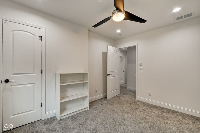 unfurnished bedroom with light carpet and ceiling fan