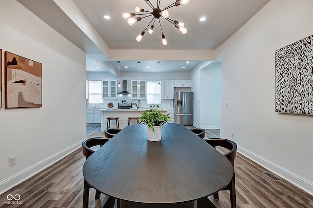 dining room with a notable chandelier and dark hardwood / wood-style flooring