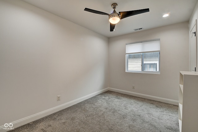 carpeted spare room featuring ceiling fan