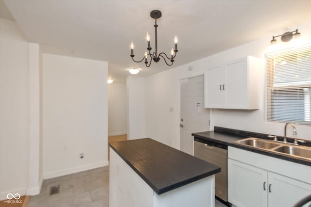 kitchen featuring a center island, white cabinetry, dishwasher, and a notable chandelier