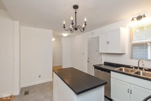 309 N Lasalle St, Indianapolis, IN 46201 - kitchen featuring stainless steel dishwasher, dark countertops, a sink, white cabinetry, and a notable chandelier