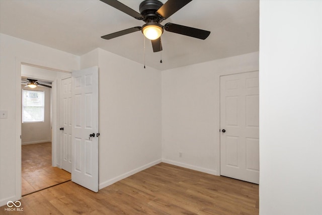 309 N Lasalle St, Indianapolis, IN 46201 - unfurnished bedroom with baseboards, light wood-style floors, and ceiling fan
