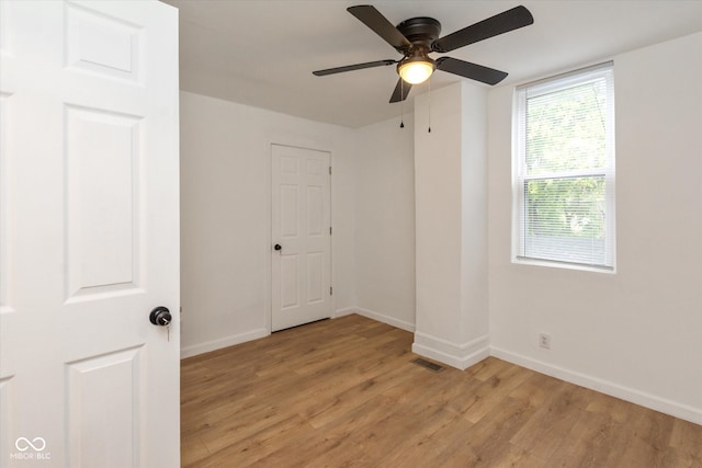 spare room featuring light hardwood / wood-style floors and ceiling fan