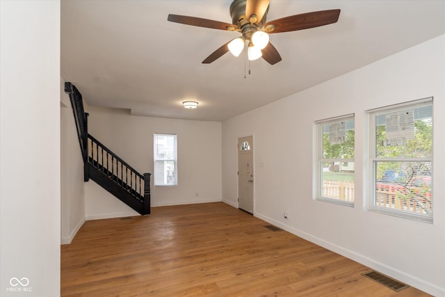 entrance foyer featuring ceiling fan, light hardwood / wood-style flooring, and a wealth of natural light