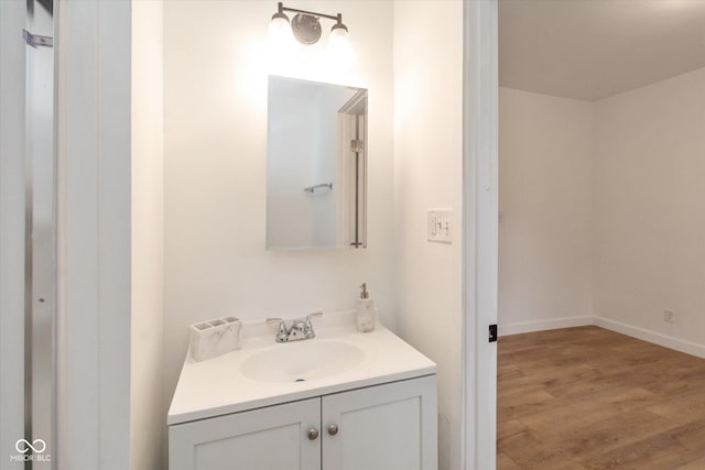 309 N Lasalle St, Indianapolis, IN 46201 - bathroom featuring baseboards, wood finished floors, and vanity