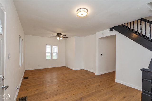 unfurnished living room featuring ceiling fan and light wood-type flooring