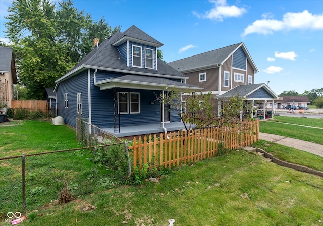 view of front of home with a front yard and covered porch