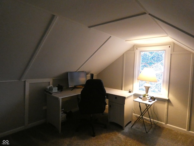 carpeted home office with lofted ceiling