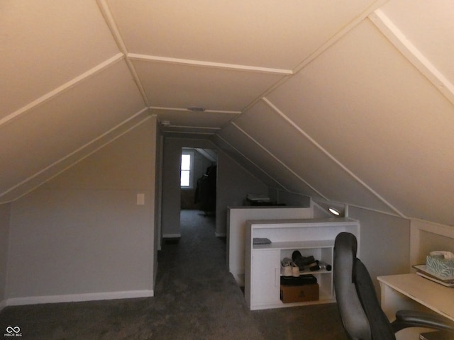 bonus room featuring lofted ceiling and dark carpet