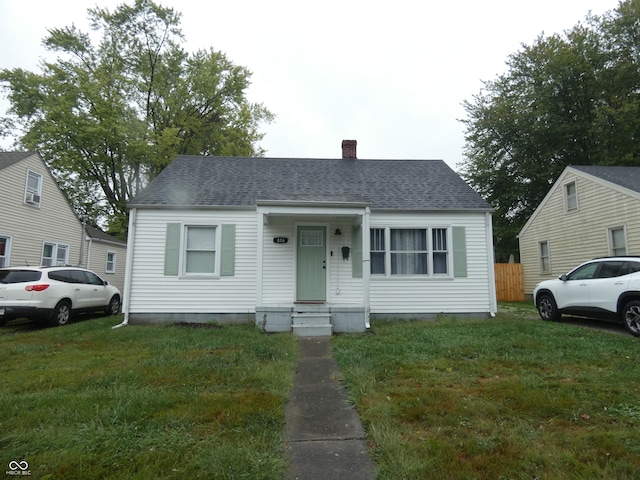 bungalow-style house with a front yard