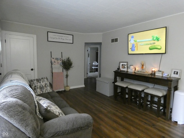 living room with crown molding and dark hardwood / wood-style flooring