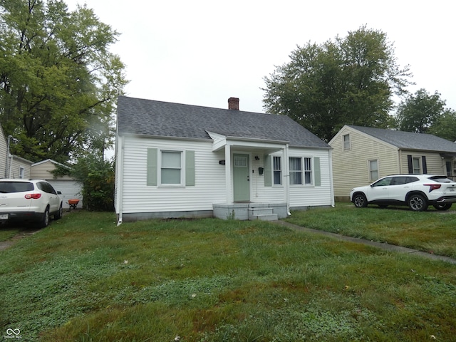 bungalow-style home with a front lawn