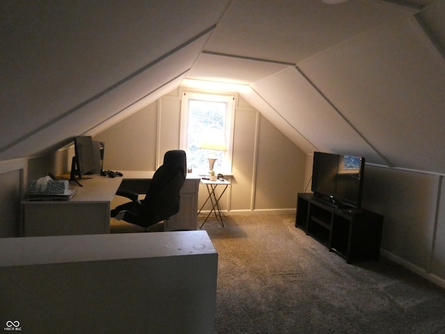 carpeted home office featuring lofted ceiling