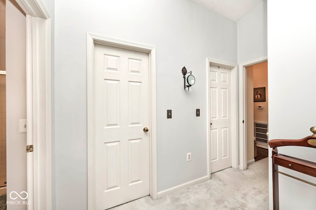 interior space with light colored carpet and a textured ceiling