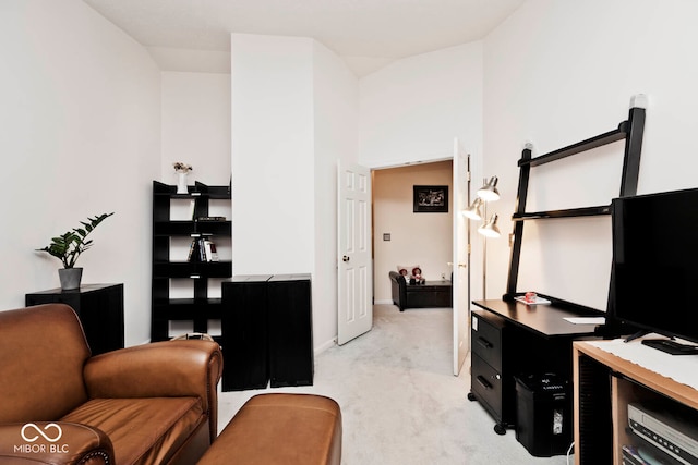 carpeted home office featuring lofted ceiling