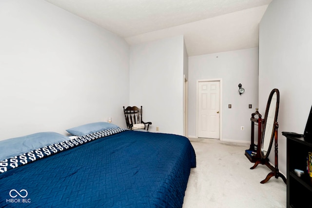 carpeted bedroom with lofted ceiling