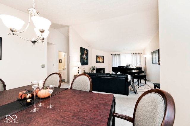 carpeted dining area featuring vaulted ceiling and a notable chandelier