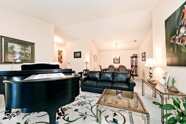 living room with light carpet, a chandelier, and vaulted ceiling