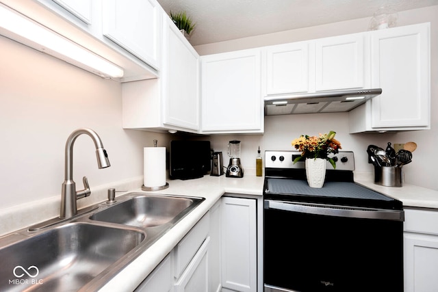 kitchen with electric stove, white cabinetry, ventilation hood, and sink