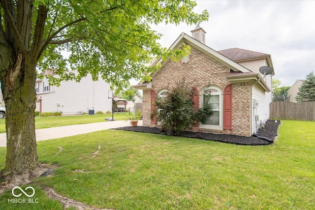 view of side of home featuring a lawn