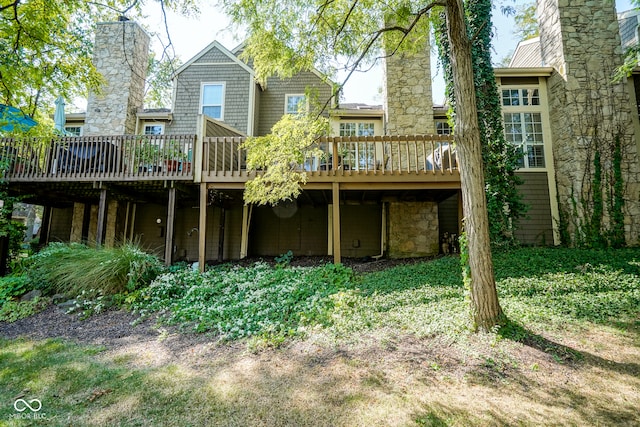 rear view of house with a chimney and a deck