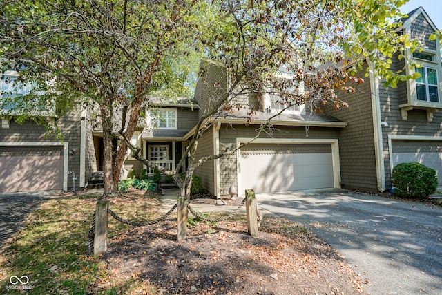 view of front facade featuring a garage and aphalt driveway