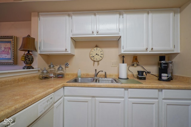 kitchen featuring dishwasher, white cabinetry, light countertops, and a sink