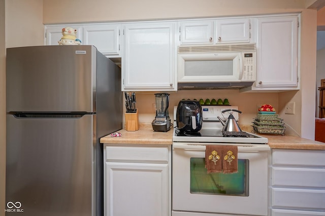 kitchen with light countertops, white appliances, and white cabinetry